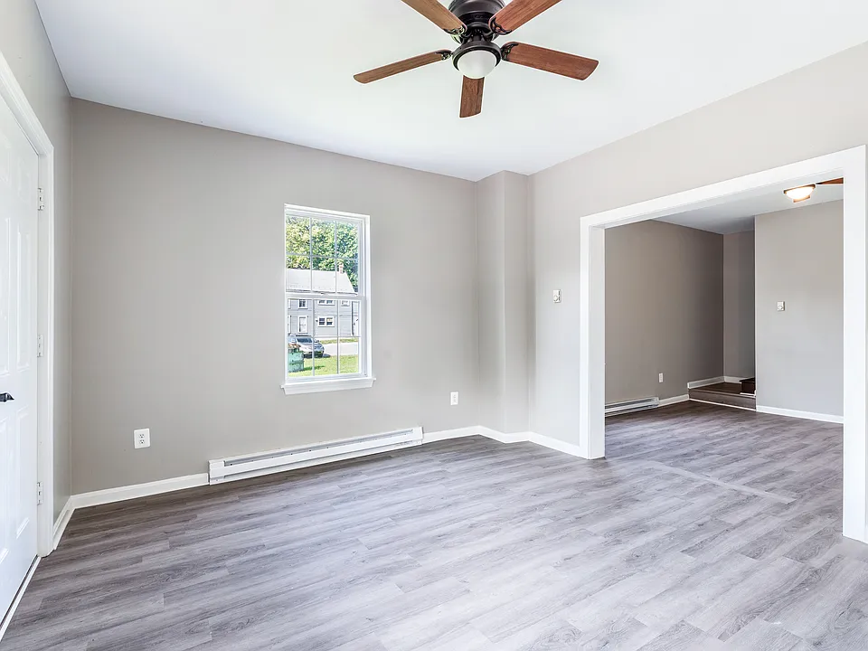 Living Room with door to the front of the house. Dinning room or additional living room, entry way to bottom of stairs