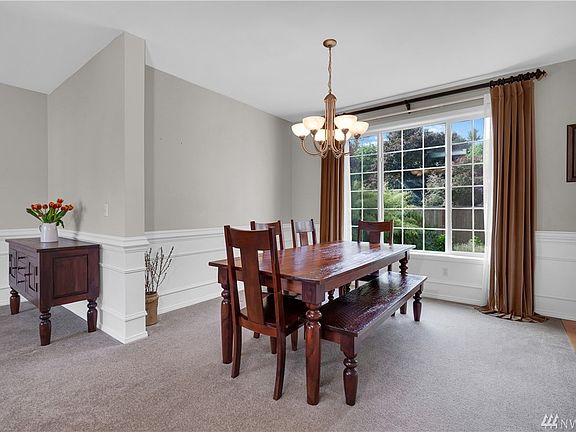Formal dining room with large window overlooking the back yard