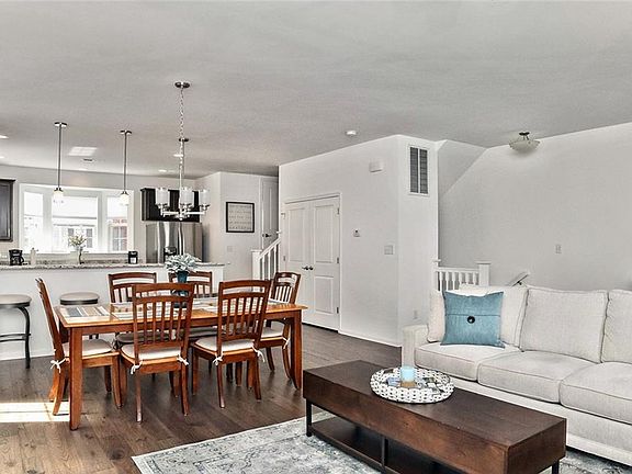 Gorgeous engineered hardwood flooring throughout the main living area showcases the spacious and open floorplan.