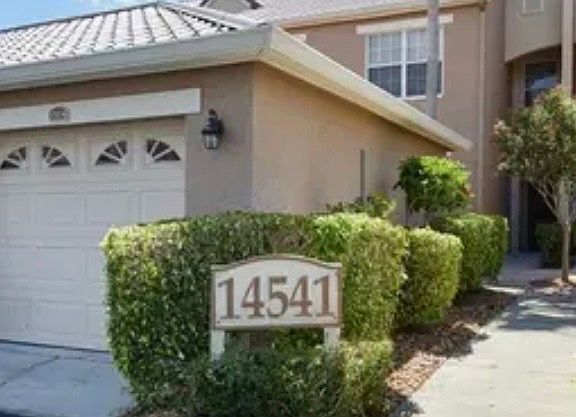 Detached parking garage with. private court yard entry to condo.
