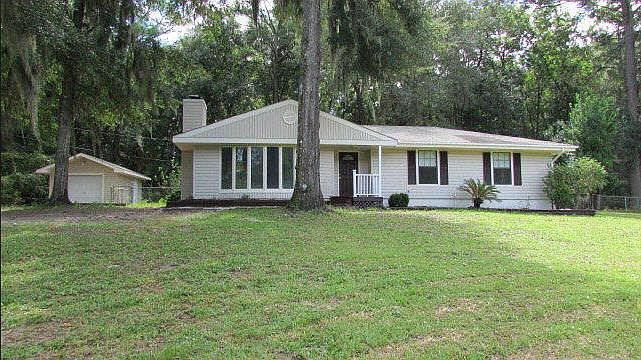 View of the garage and house from the street. Note the large front yard!