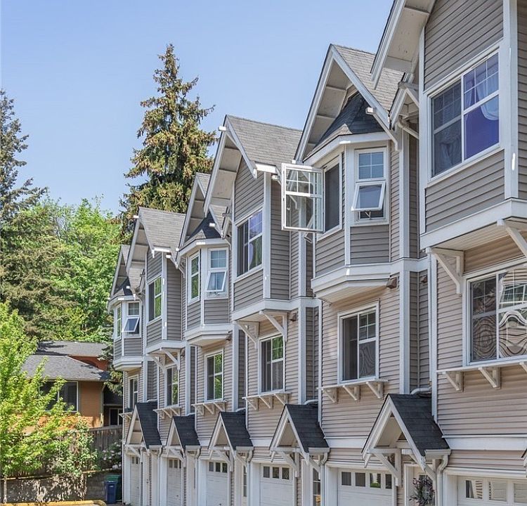 Charming multi-level townhome exterior in a beautifully maintained community.