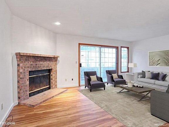 Living Room w/cozy wood burning fireplace & slider to covere