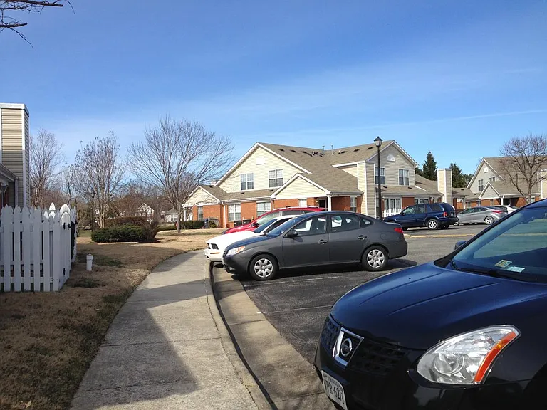 Outside with two parking spots in front of the house