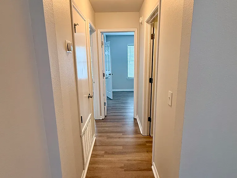 Hall to two of the bedrooms, including the Master Bedroom on the left. Laundry to the right.