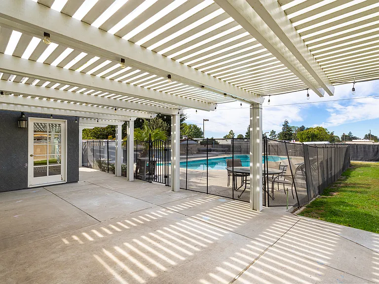 Rear Alumawood Patio with access to pool area.