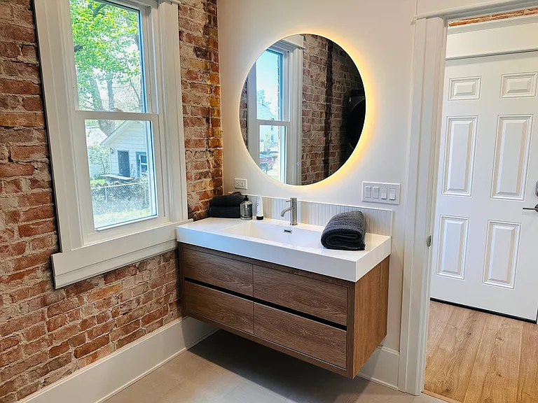 Floating vanity with back lit mirror.