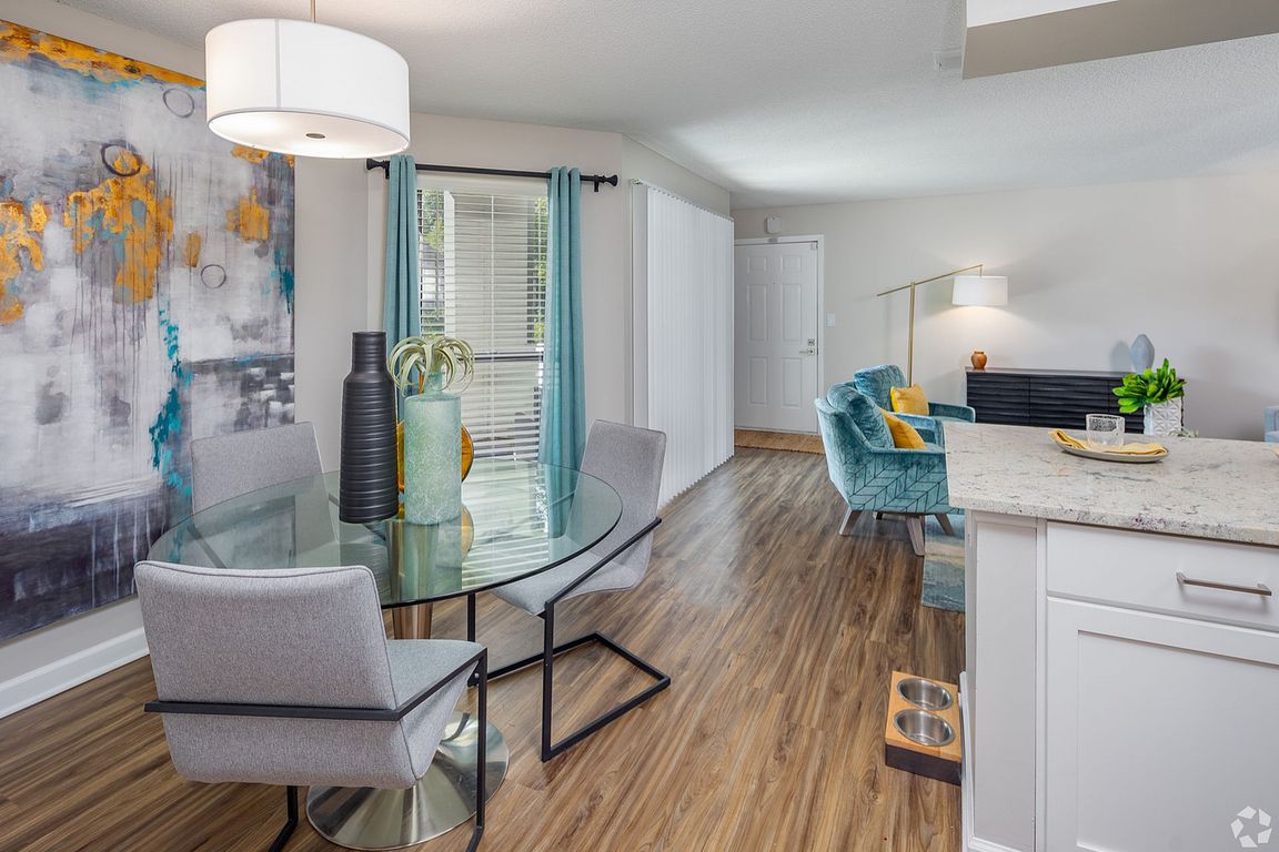Dining area with hardwood-style flooring & built-in lighting