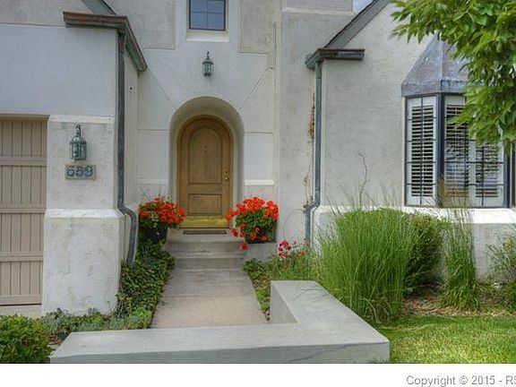 French Country style with amazing curb appeal.  Beautiful patina on the copper topped bay window and downspouts.