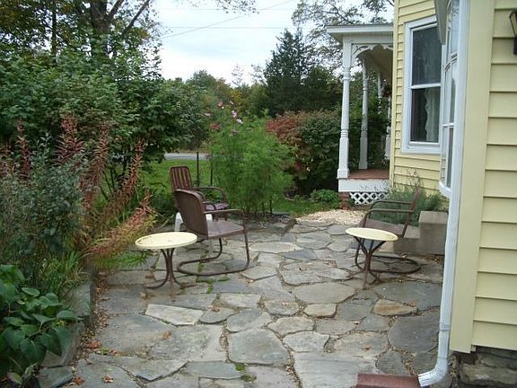 Part of L-shaped fieldstone patio surrounding Sunroom