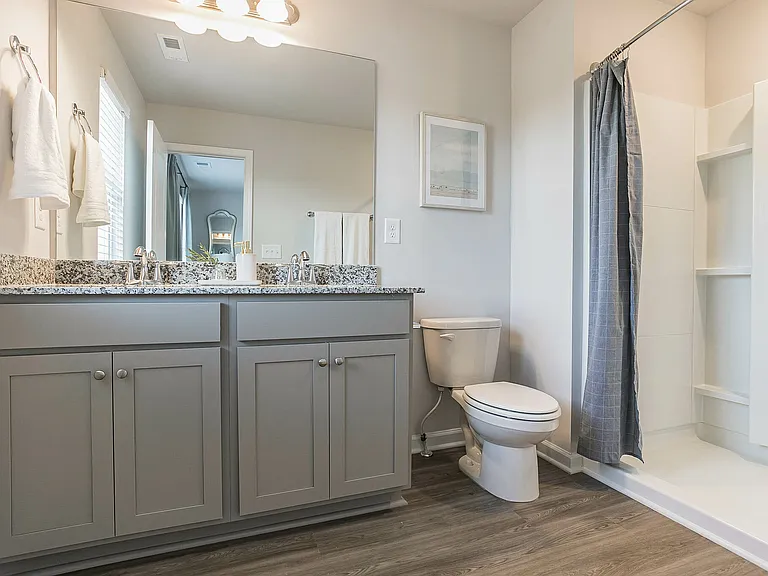 Spacious bathroom with dual vanity, walk-in shower, and stylish finishes