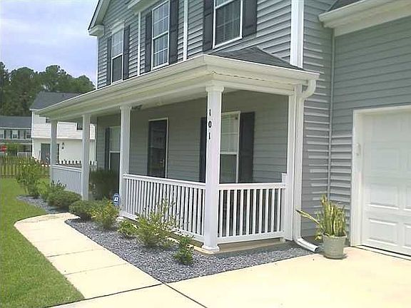 The front of the house accentuated by the charming full front porch.