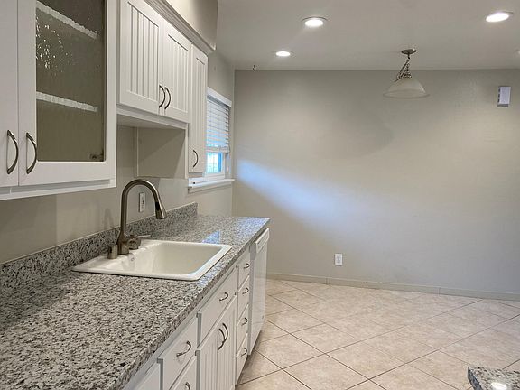 Kitchen with granite countertops showing eating area