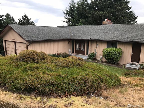 Great lighting from the floor to ceilings windows. Wood burning fireplace, Wilkinson stone faced fireplace on living room and dining room sides. Open vaulted beamed ceilings. 