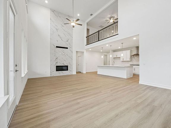 Stunning optional fireplace in gathering room photos depict features and options that may not be av