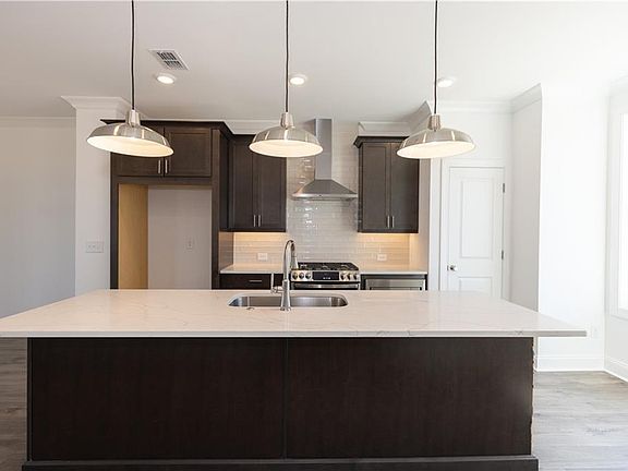 This large island is great for casual dining Photos are not of actual home but of previously bui