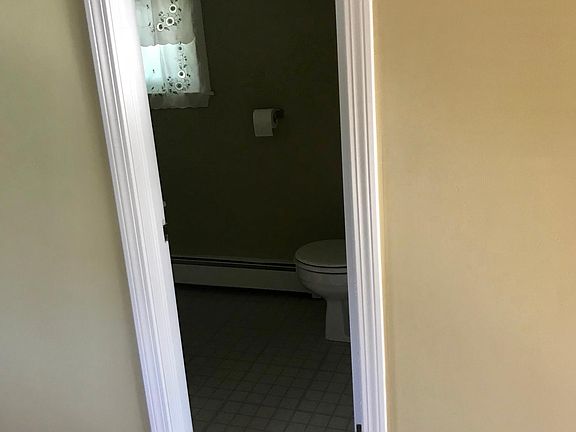 Bathroom off of kitchen with tub/shower, sink and toilet. First floor.