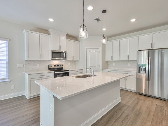 Designer-curated finishes, including quartz countertops create an elegant feel.