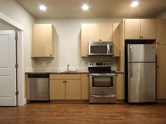 Kitchen w/ oversize sink, oven/range, fridge, microwave, dishwasher.