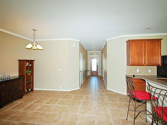 Entrance hallway leads to kitchen & living room area