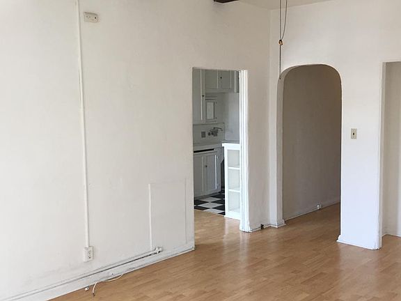 main room looking at kitchen and hallway to front door