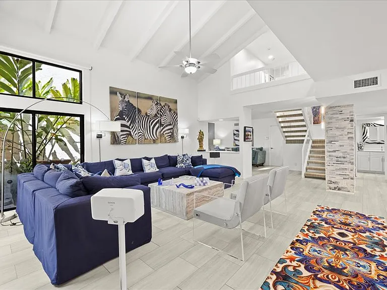View of living room and stairway to second floor.