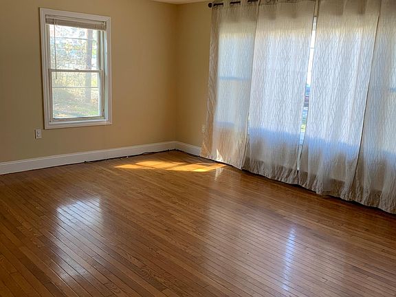 Big living room has a big window gives lot of light into the room.