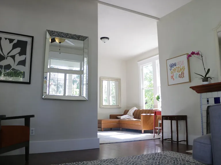 View from the front parlor into the living room. High and vaulted ceilings throughout the home.