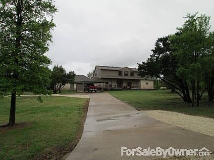 front of house with garage & carport