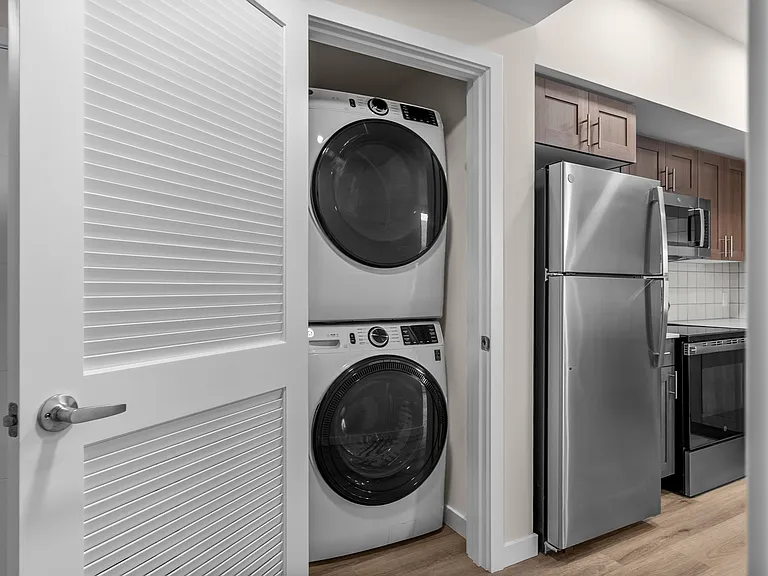Convenient in-home laundry with modern stacked washer and dryer. Convenient in-home laundry with modern stacked washer and dryer.