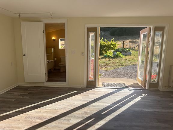 View out French doors, bathroom on left