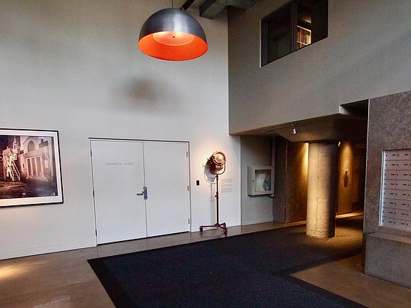 Lobby with entrance to Amenity Room and window showing Library on second floor