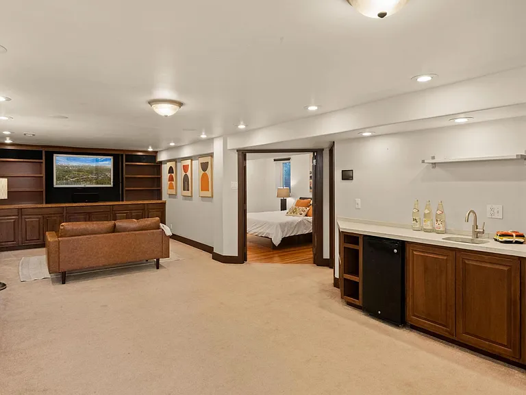 Basement level large living space, wet bar, TV included