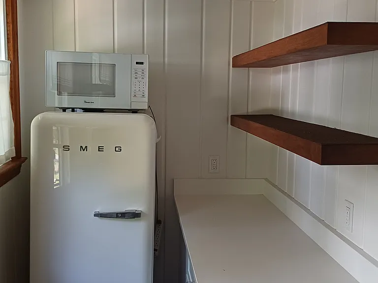 The stylish, space-saving refrigerator is complemented with a full one in the basement family room.