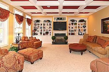 Family Room with Coffered Ceiling, Gas FP, Built Ins, and Plush Carpet