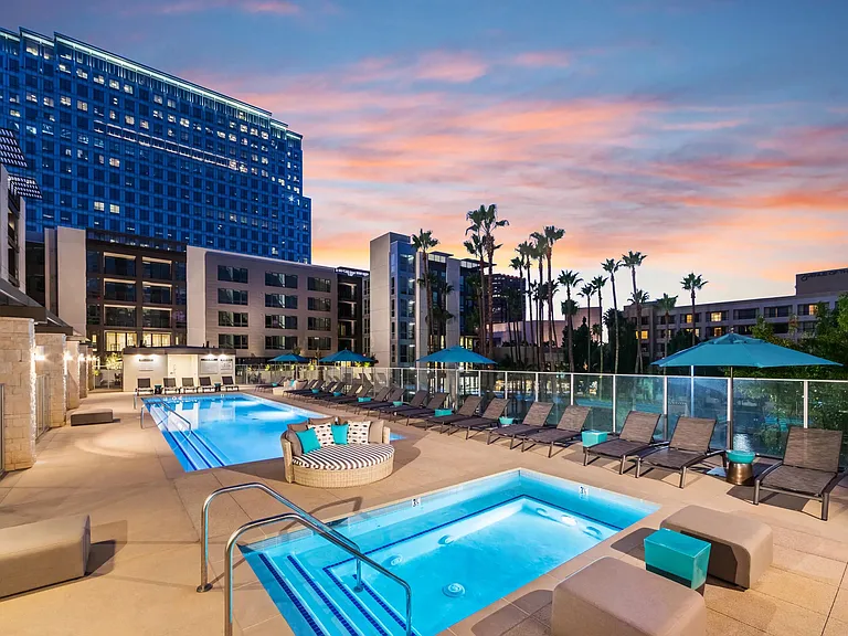 Resort_inspired pool deck with spa and chaise lounges for relaxing outdoor time.