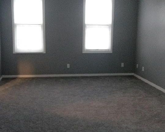 Living room and the wood floor is part of dining area