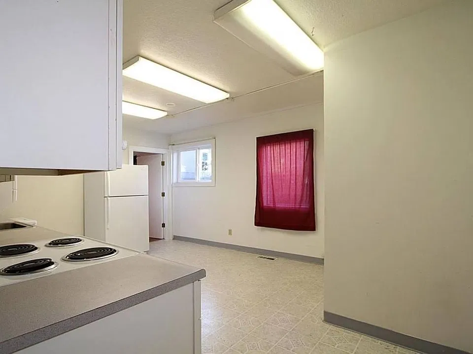 Kitchen with access to adjacent bedroom; sliding door opens to private patio