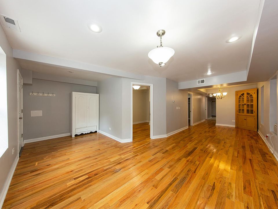 This unit features almost 1200 sq ft of living space. Featured in this photo is the large living room with 7.5' ceilings and hardwood floors!