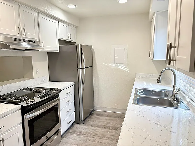 Experience culinary delight in this sleek modern kitchen, featuring top-line appliances and elegant finishes.