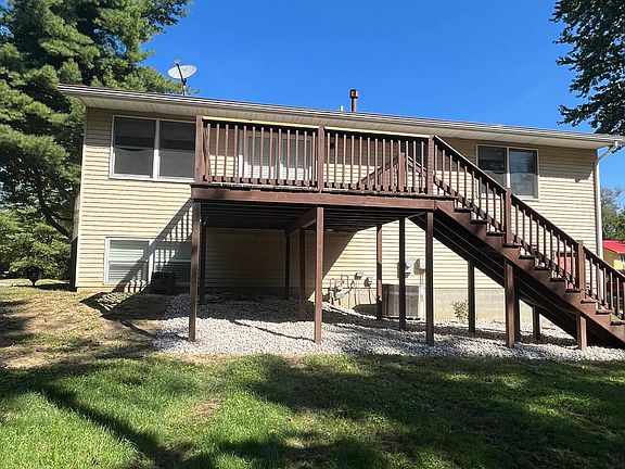 Back of house with deck and new landscaping; ongoing lawn service included