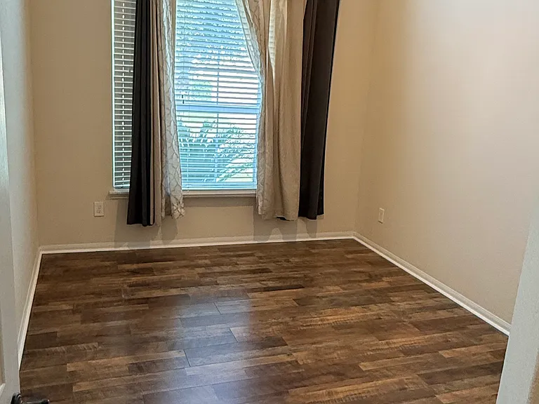 Second bedroom has tall ceilings and view of the front