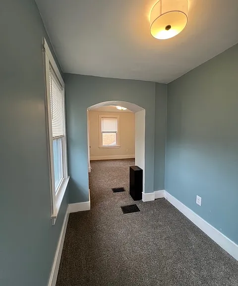 Spacious bedroom/nursery including 2 closets, updated paint and brand new lighting. Laundry chute located in the middle of the bedroom.