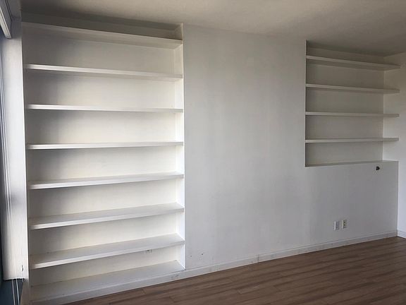 Shelving on one wall of master bedroom.