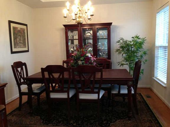 Dining Room with lrecessed ceiling and beautiful hardwood floors.