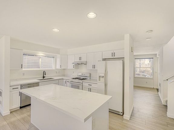 Updated kitchen with large island and quartz countertops.