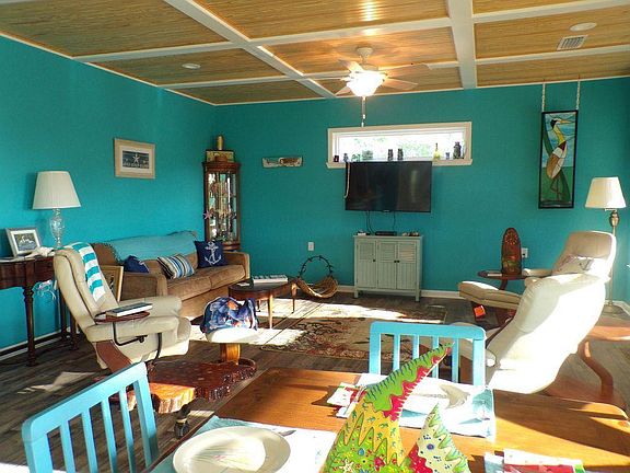 Open dining and living room which faces the water.