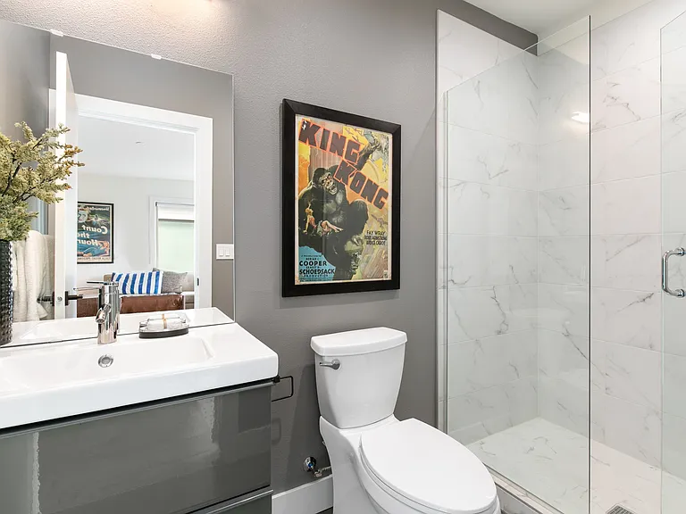 Top-level room ensuite 3/4 bathroom with marble vanity and wall, plus radiant heated floors for added comfort.