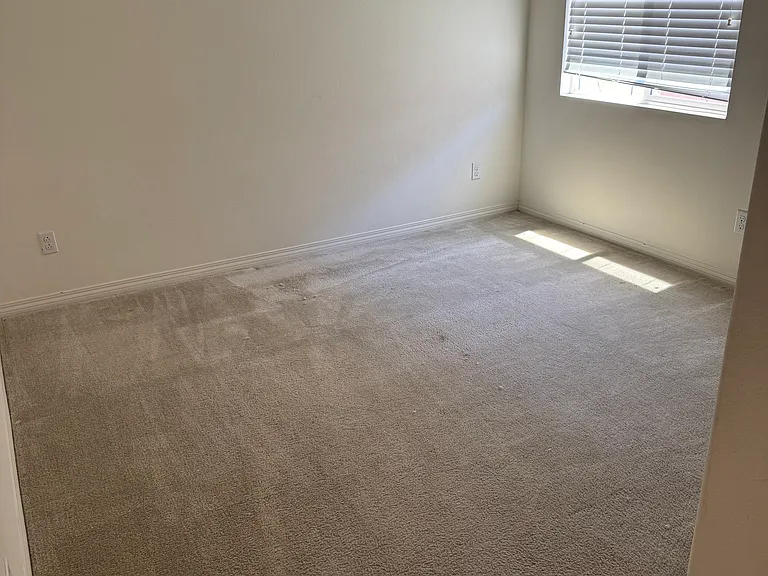 View of second upstairs bedroom with ceiling fan/light, with large walk-in closet.