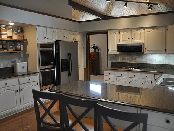 Marble counters, double over, gas range, and over-range microwave.